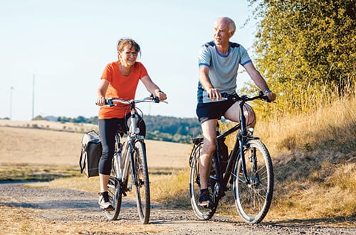 Senior couple riding their bicycles for better fitness and health benefits